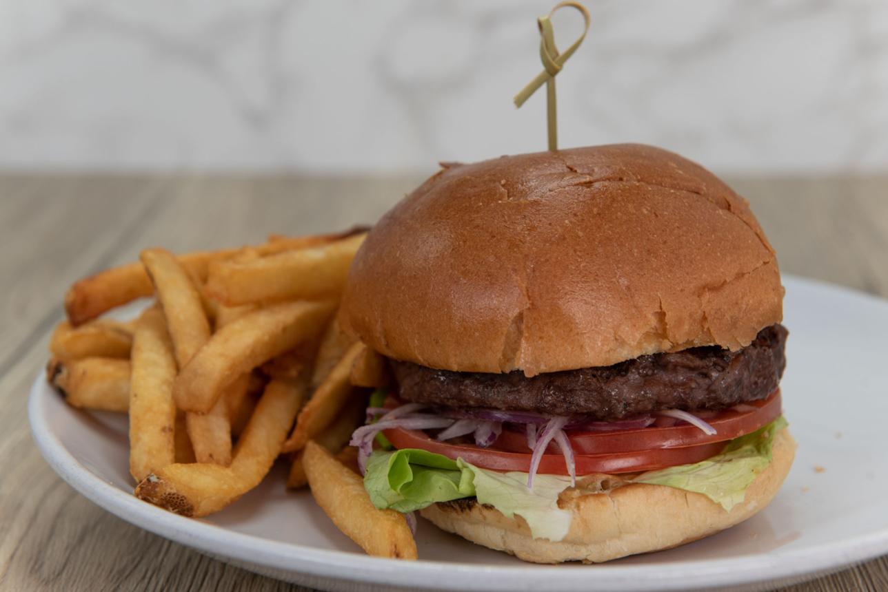 A burger and fries served on a plate