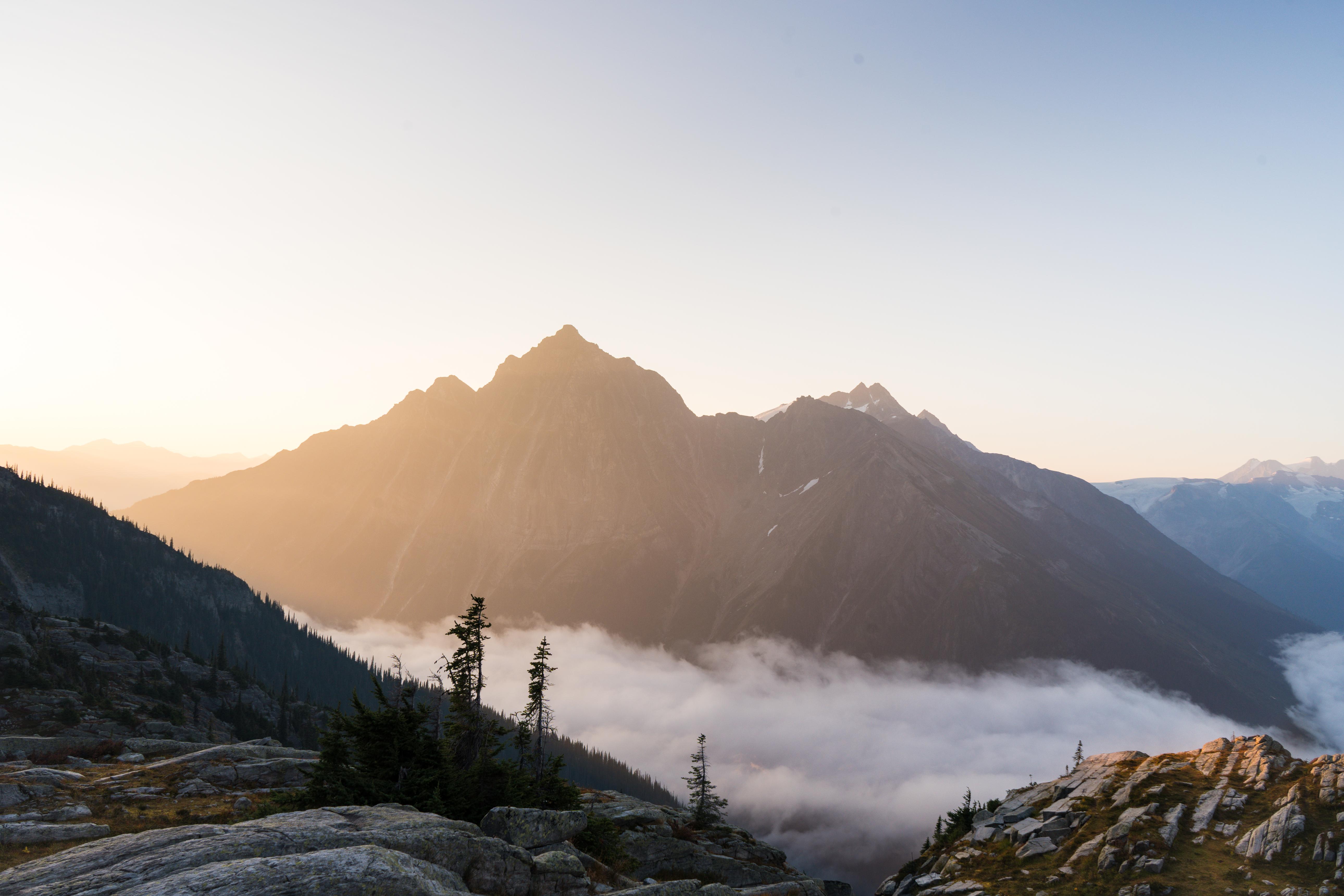 Mountain landscape with fog and sunrise lighting