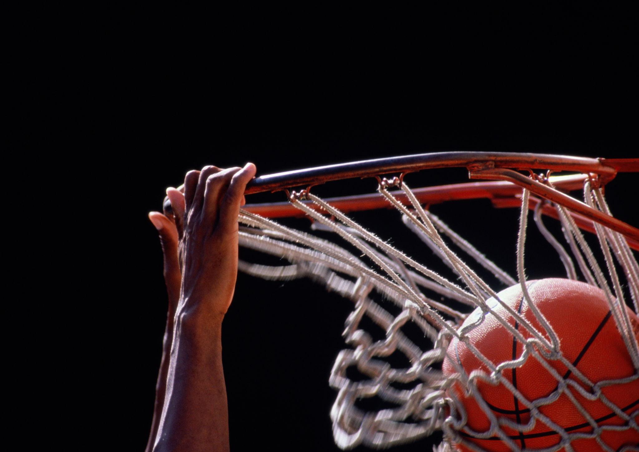 Basketball going through the hoop during a game